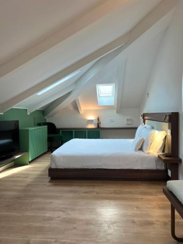 a bedroom with a large bed in a attic at Boutique Hotel Martini 17 in Milan