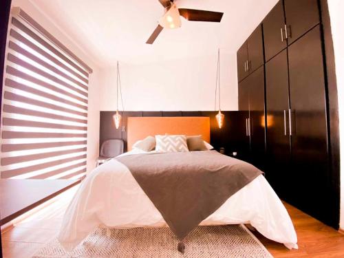 a bedroom with a bed and a ceiling fan at Cielito Home in Jesús María