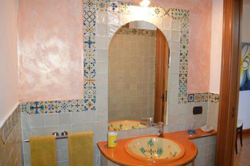 a bathroom with a sink and a mirror at Villetta Lavanda in Lipari
