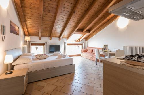 a bedroom with a bed and a living room at La Filanda Apartments by Wonderful Italy - Canapa in Bellagio