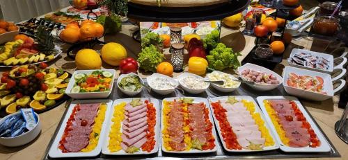 a table topped with lots of different types of food at DORMERO Hotel Hannover-Langenhagen Airport in Hannover