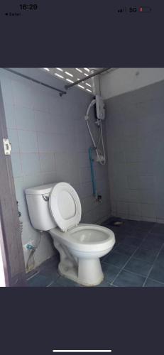 a bathroom with a white toilet in a stall at โชคชัยแมนชั่น บางบัวทอง in Nonthaburi