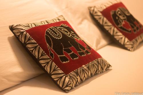 a close up of two pillows on a bed at The Calm Cabana in Dambulla