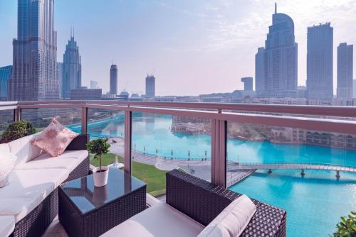 a balcony with a couch and a view of the city at Elite Royal Apartment - Full Burj Khalifa & Fountain View - Sapphire in Dubai