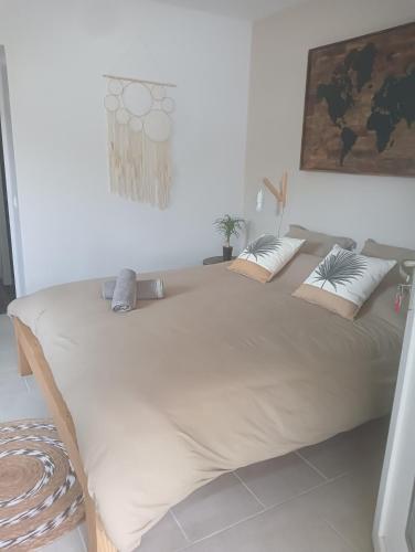 a large bed in a white room with at La Chouette Villa ,chambre de 20m2 totalement indépendante avec terrasse in Cannes-et-Clairan