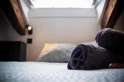 a bedroom with a bed with a pillow and a window at Onefam Sungate in Madrid