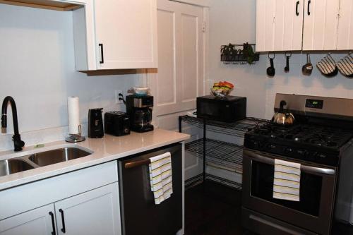 a kitchen with a sink and a stove top oven at Apt - Columbia Tusculum - Patio(2) in Cincinnati