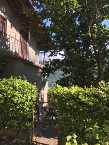 a gate in front of a building with trees at Al Termen in Sondrio