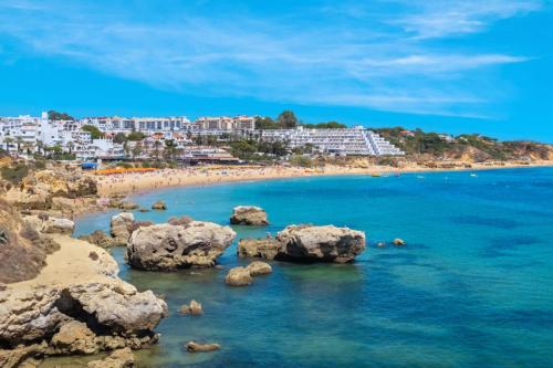 a view of a beach with rocks in the water at Hotel da Aldeia - Adults Only in Albufeira