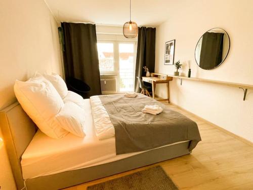 a bedroom with a bed in a room with a mirror at Altstadt-Wohnung im Weidener Zentrum in Weiden