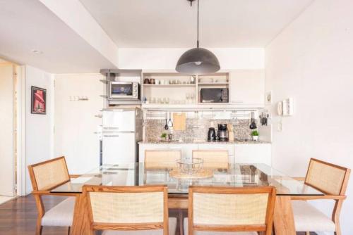 a dining room with a glass table and chairs at Quartier San Telmo Suites 10 in Buenos Aires