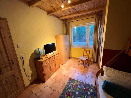 a bedroom with a bed and a television on a dresser at Haus Krabbe mit Strandkorb inkl in Göhren