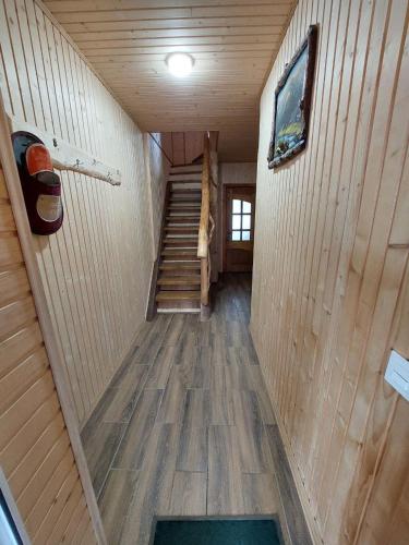 a hallway of a cabin with stairs and a stair case at Котеджі Цімбори in Yablunytsya
