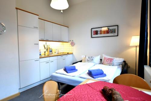 a small room with a bed and a kitchen at Gaestehaus-St-Josef-2 in Borkum