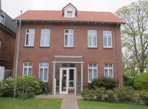 a red brick house with a white door at Gaestehaus-St-Josef-2 in Borkum