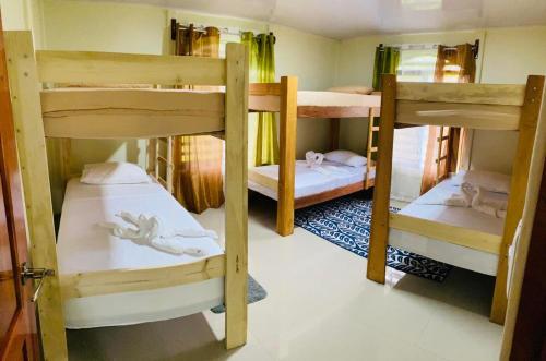 a group of bunk beds in a room at Bosque Azul de Osa in Rancho Quemado