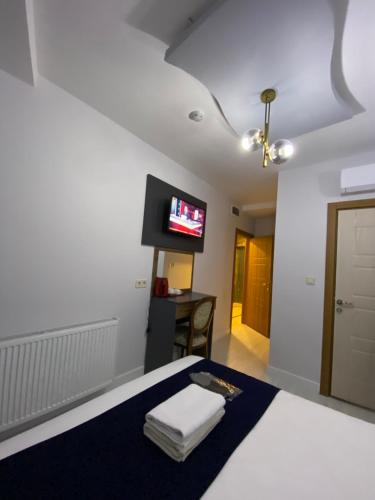 a bedroom with a bed and a flat screen tv at Ramos Boutique Hotel Sultanahmet in Istanbul