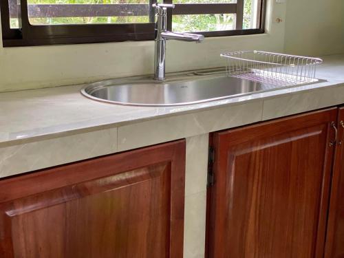 a kitchen counter with a sink and a window at Bosque Azul de Osa in Rancho Quemado