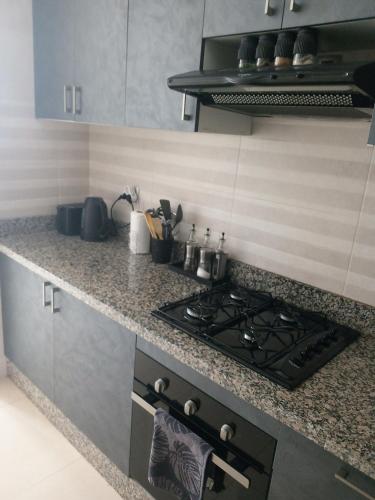 a kitchen with a stove and a counter top at home Lesieur in El Jadida