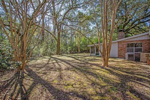 an empty yard with trees in front of a house at The Nathalie - curated, open, tree covered family in Charleston