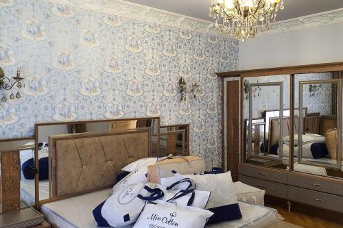 a bedroom with a bed and a mirror at Buzovna Villa in Baku