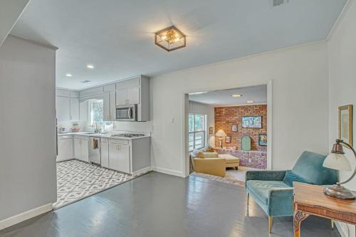 a kitchen and living room with a couch and a table at The Nathalie - curated, open, tree covered family in Charleston