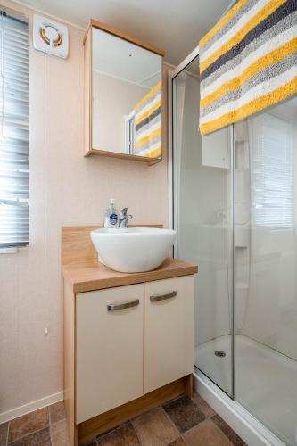 a bathroom with a sink and a shower at Lyons Retreat in Lossiemouth