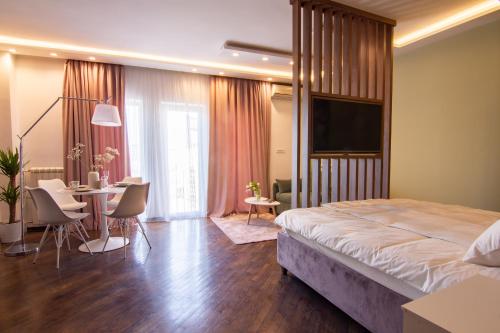 a hotel room with a bed and a table and chairs at Square 6 in Belgrade