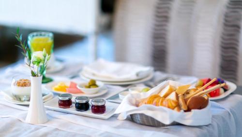 a table topped with plates of food and drinks at Vozdvyzhensky Boutique Hotel in Kyiv