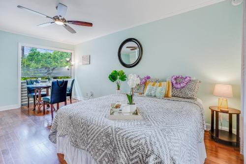 a bedroom with a bed and a table with flowers on it at Sandpiper #105b in Princeville