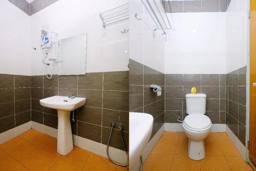 a bathroom with a toilet and a sink at Q Hotel Temerloh in Temerloh