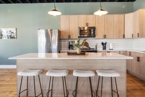 a kitchen with a large island with bar stools at Richmond No. 267 in Richmond
