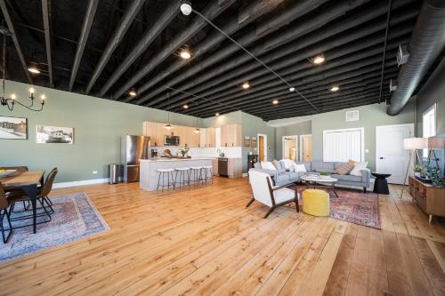 a large living room with a table and a kitchen at Richmond No. 267 in Richmond