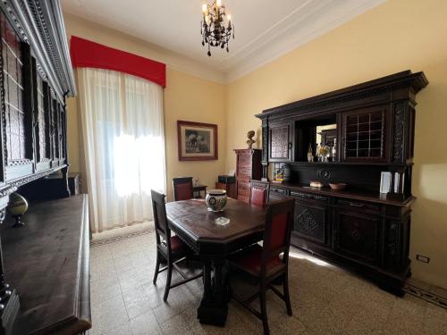 a dining room with a table and a cabinet at La Villa del Lago in Ghirla