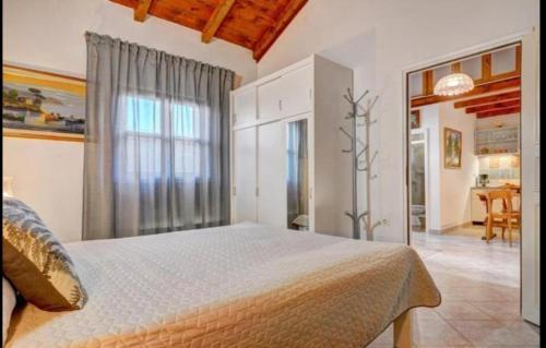 a bedroom with a large bed and a dining room at MANDULERA in Peroj