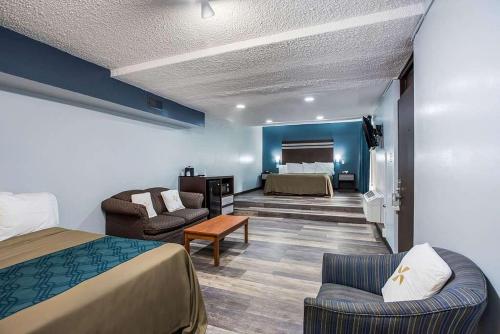 a hotel room with a bed and a living room at Red Carpet Inn & Suites NJ-73 in Hammonton
