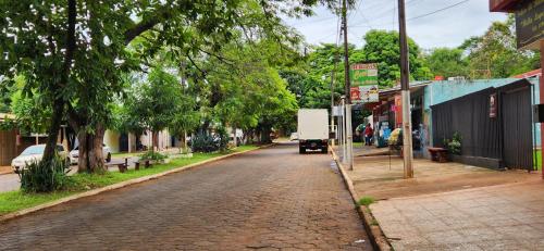 a cobblestone street in a town with trees at Casa duplex en Área 4 CDE in Ciudad del Este