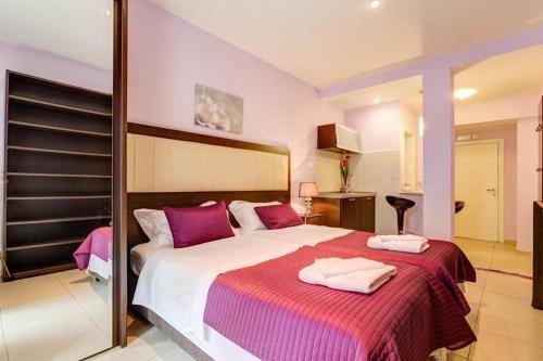 a bedroom with a large bed with two towels on it at Splendid Luxury Apartments in Budva