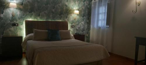 a bedroom with a bed in a room at La Casona de Revolgo in Santillana del Mar