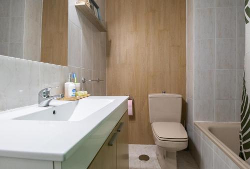 ein Badezimmer mit einem Waschbecken, einem WC und einer Badewanne in der Unterkunft O sete dos Soportais in Pontevedra
