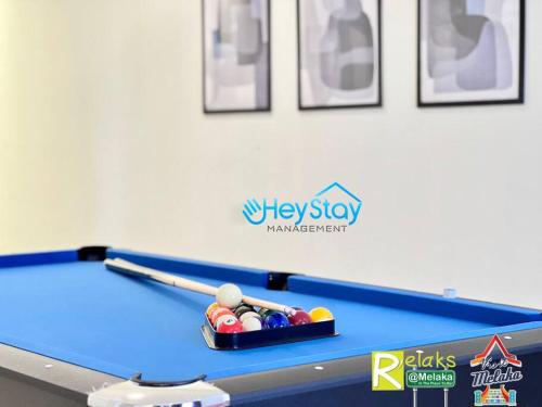 a pool table with balls in a box on it at The Apple Residence By Heystay Management in Melaka