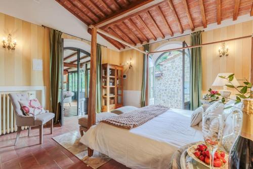 a bedroom with a bed and a table with fruit on it at Villa Veranda, a Romantic Farmhouse with Pool in Larciano