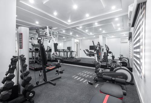 a gym with treadmills and cardio equipment in a room at BKT Cribs - Apartments & Suites in Abuja
