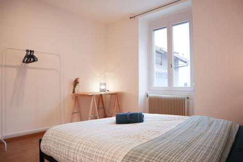 a bedroom with a bed with a blue suitcase on it at Appartement 3 pièces, idéal famille et travail, parking gratuit in Mulhouse