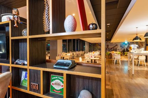 a restaurant with wooden walls and tables and chairs at Holiday Inn Liverpool City Centre by IHG in Liverpool