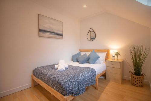 a bedroom with a bed with a blue comforter at Sealock Mews by Property Promise in Cardiff
