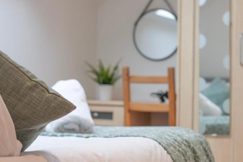 a close up of a couch with a mirror and a mirror at Sealock Mews by Property Promise in Cardiff