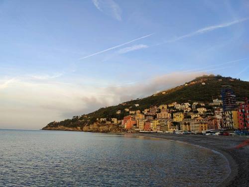 a town on a hill next to a body of water at La Casa di Milly in Sori