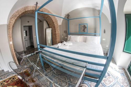 a bedroom with a bed with a blue railing at Hotel Rural La Casa de Carlota in Montánchez