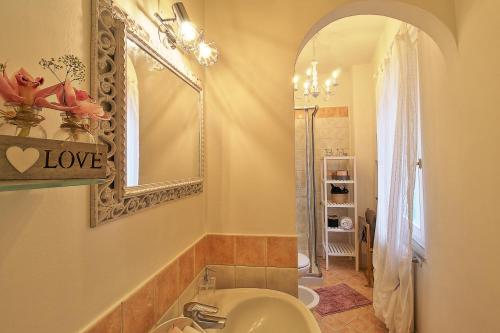 een badkamer met een wastafel en een spiegel bij Casa Peppa in Lazise